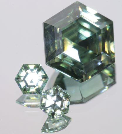 Multicolored Dichroic Moissanite stones, showing a green color with flashes of blue and yellow